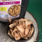 A crispy, golden-brown bowl of Oats Chips, made from oat millets, urad flour, and tapioca flour, lightly seasoned with Indian spices and iodized salt. Roasted, not fried, these chips are infused with cottonseed oil for flavoring, offering a wholesome and crunchy snacking experience.