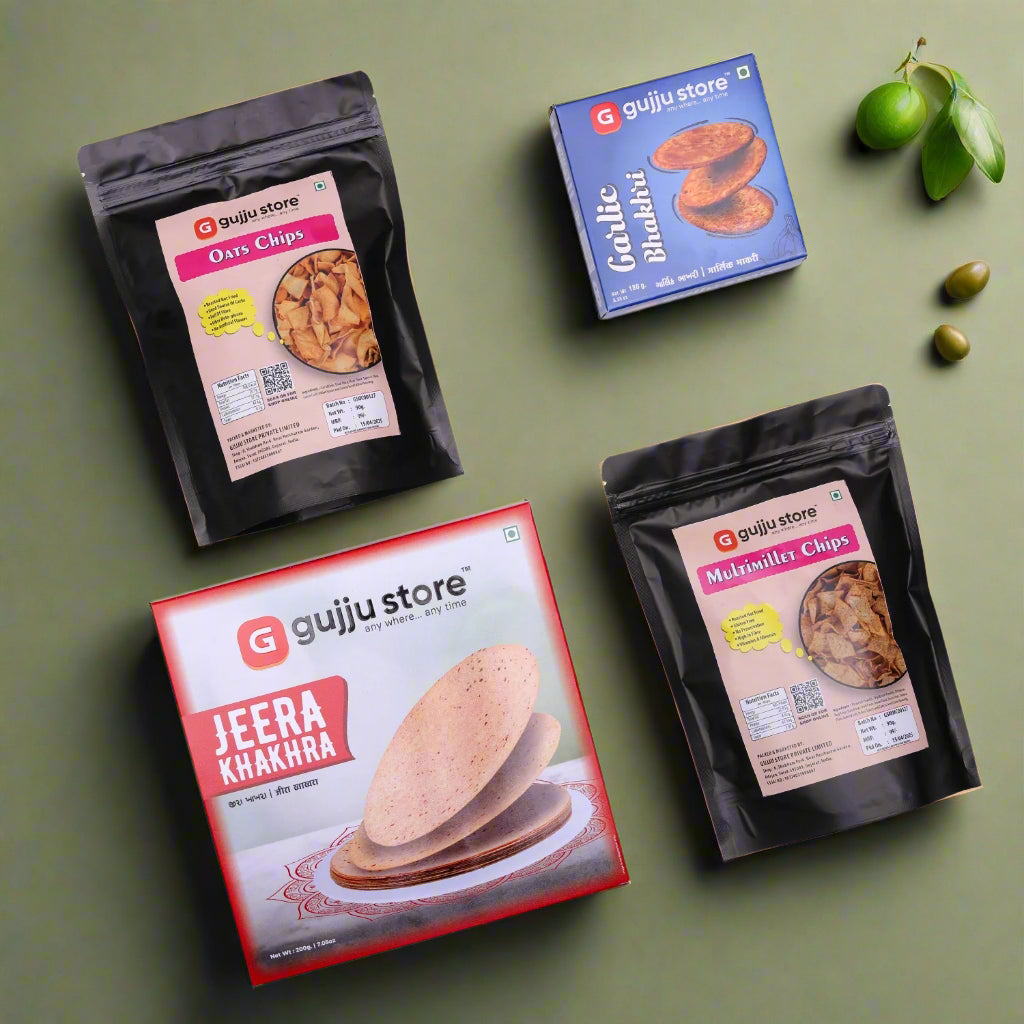 A collection of five Gujju Store snack products arranged on a white background. The items include a red and white box of Jeera Khakhra, a blue box of Garlic Bhakhri, a black pouch of Oats Chips, a black pouch of Multimillet Chips, and all products are attractively packaged with bold branding and clear labeling.